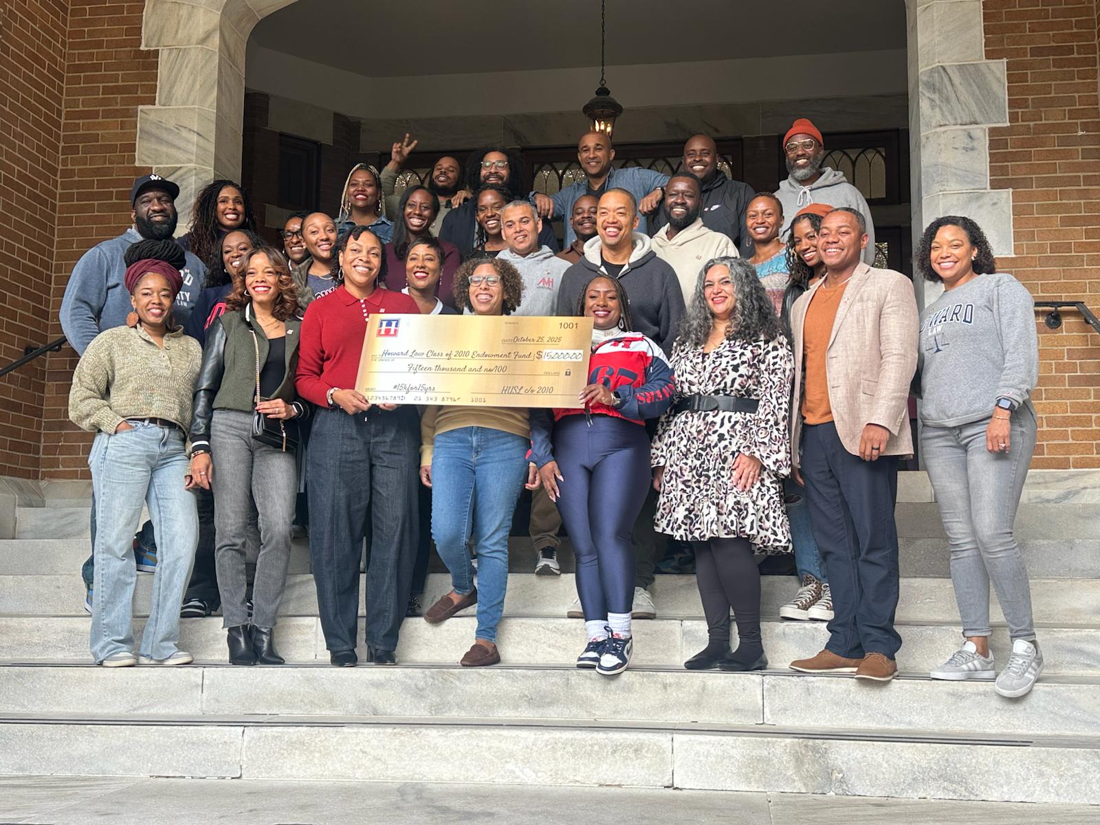 Howard Law Class of 2010 alumni gathered with a scholarship check